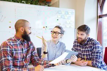 Two men and a woman holding a meeting